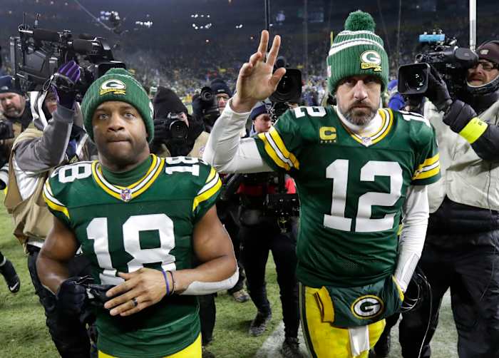 WR Randall Cobb (18) and QB Aaron Rodgers (12) leave Lambeau Field after the Packers' 2022 regular season finale